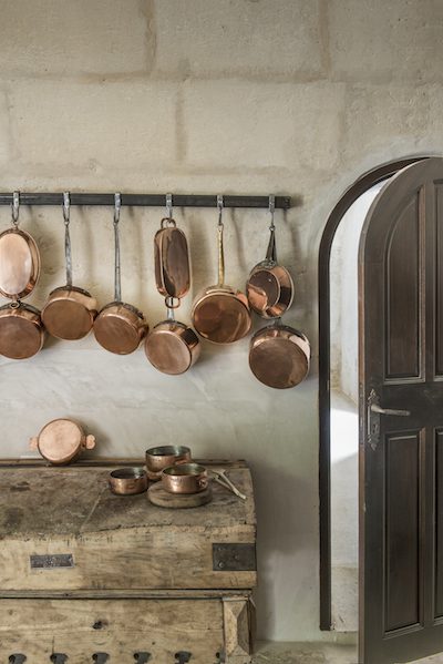 authentic french copper pans and an open kitchen door to the right