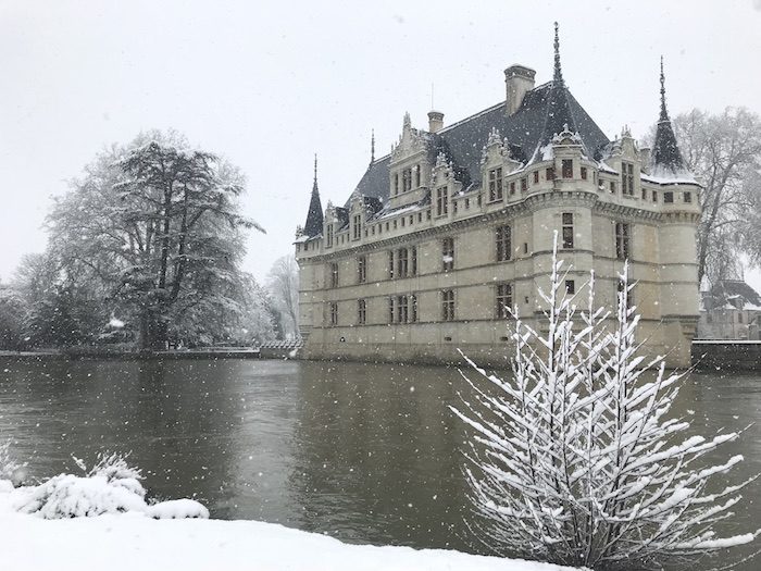 view of Azay-le-rideau from the water in winter mfch chateau in snow