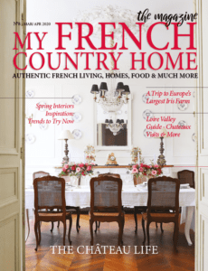 formal french dining room with table covered in white table cloth with flowers