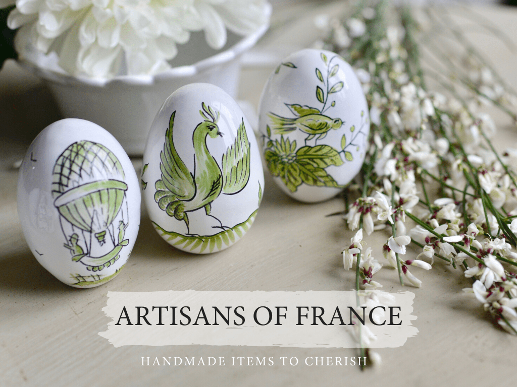 three handmade earthenware eggs, painted green with decorative motifs