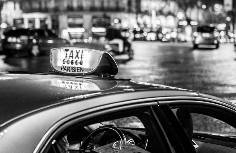 the roof of a parisian taxi, on freshly rained streets