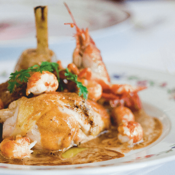 Alain Ducasse Chicken Fricasse Bistro a plate of Chicken Fricasse with crayfish