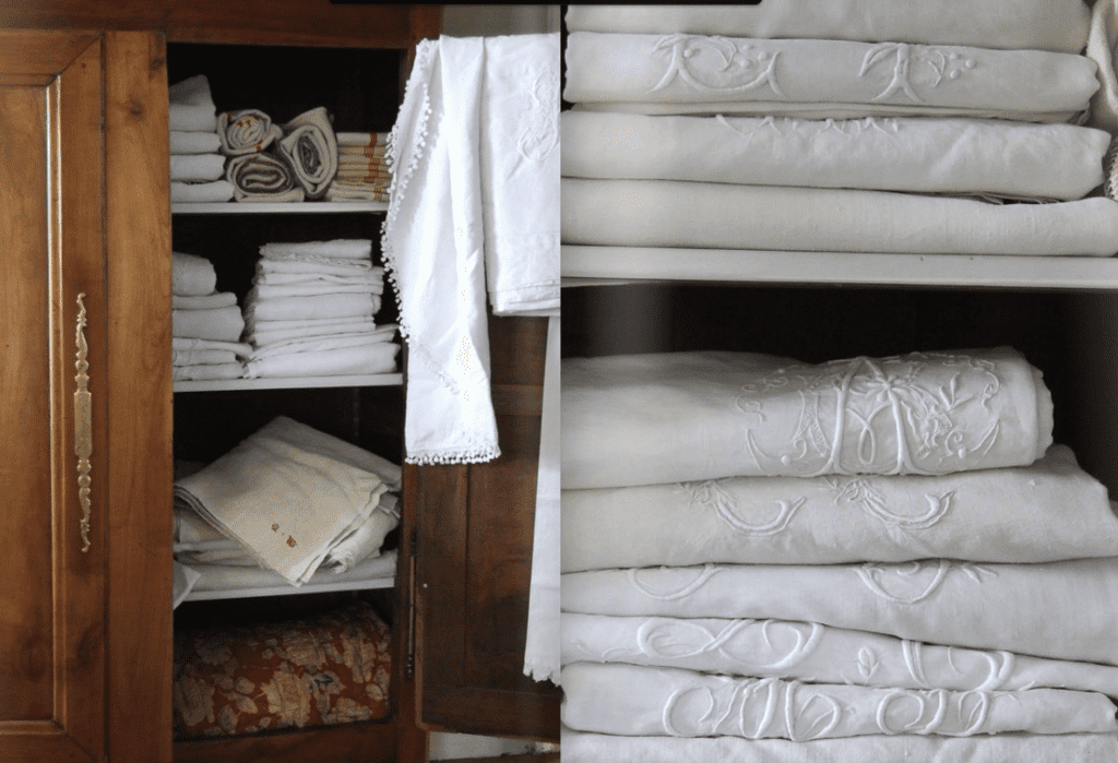 french antique linens stored in piles in an armoire