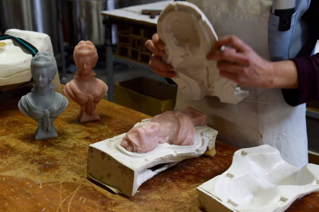 a candle bust being removed from its mould