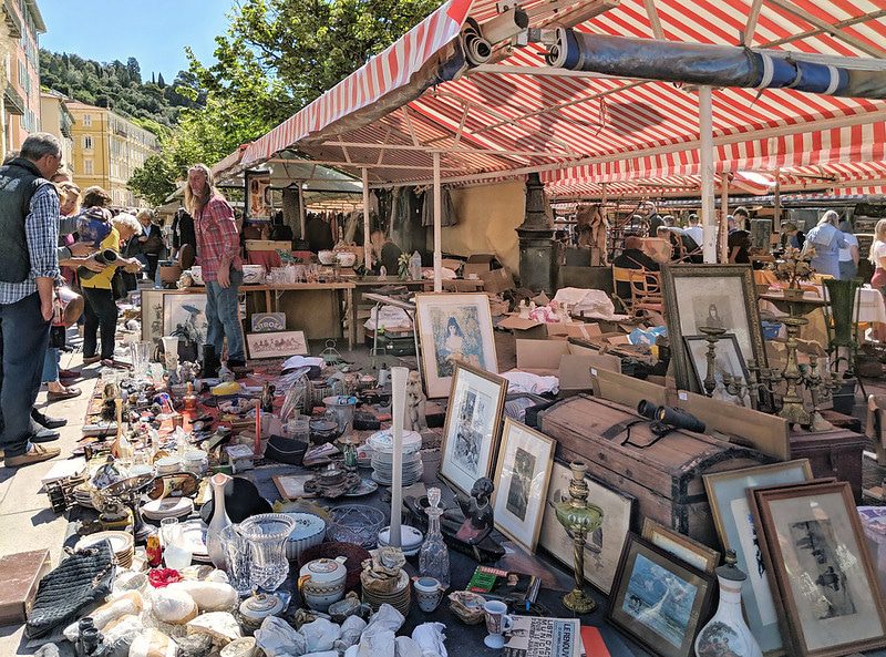 an outdoor brocante with many wares laid out on the floor