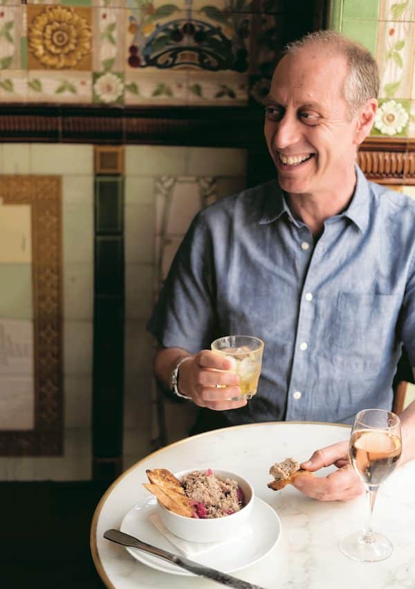 a man eating a plate of rillette pate and bread