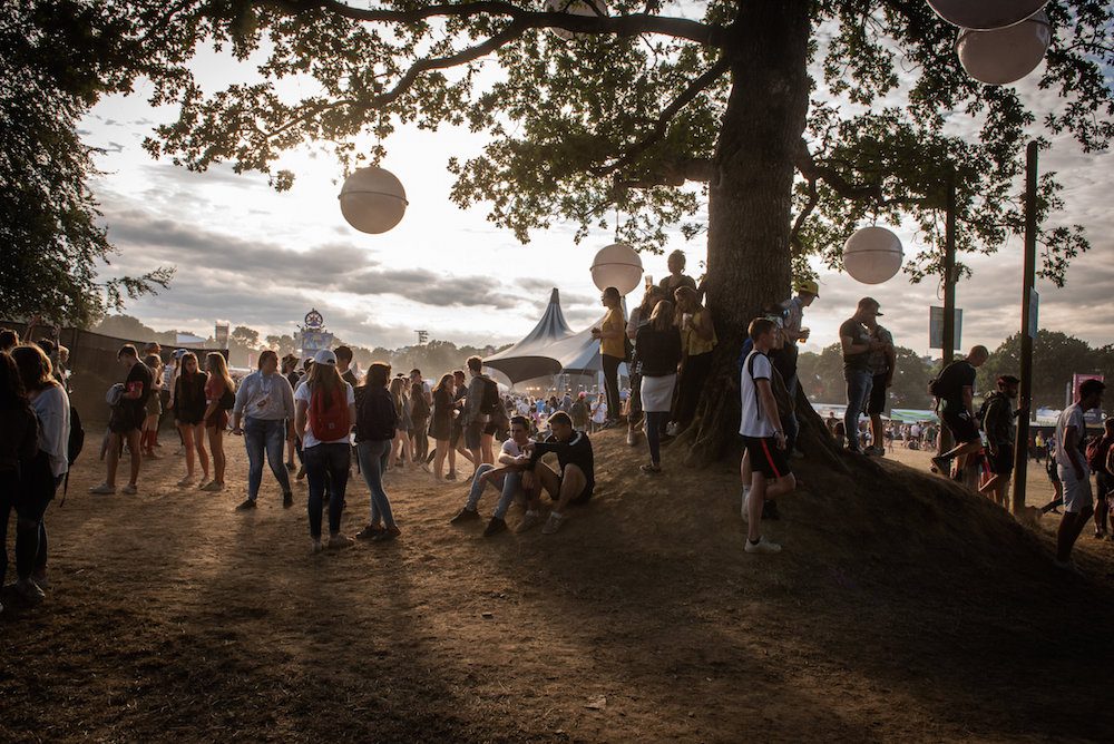 a group of people around a tree at a festival