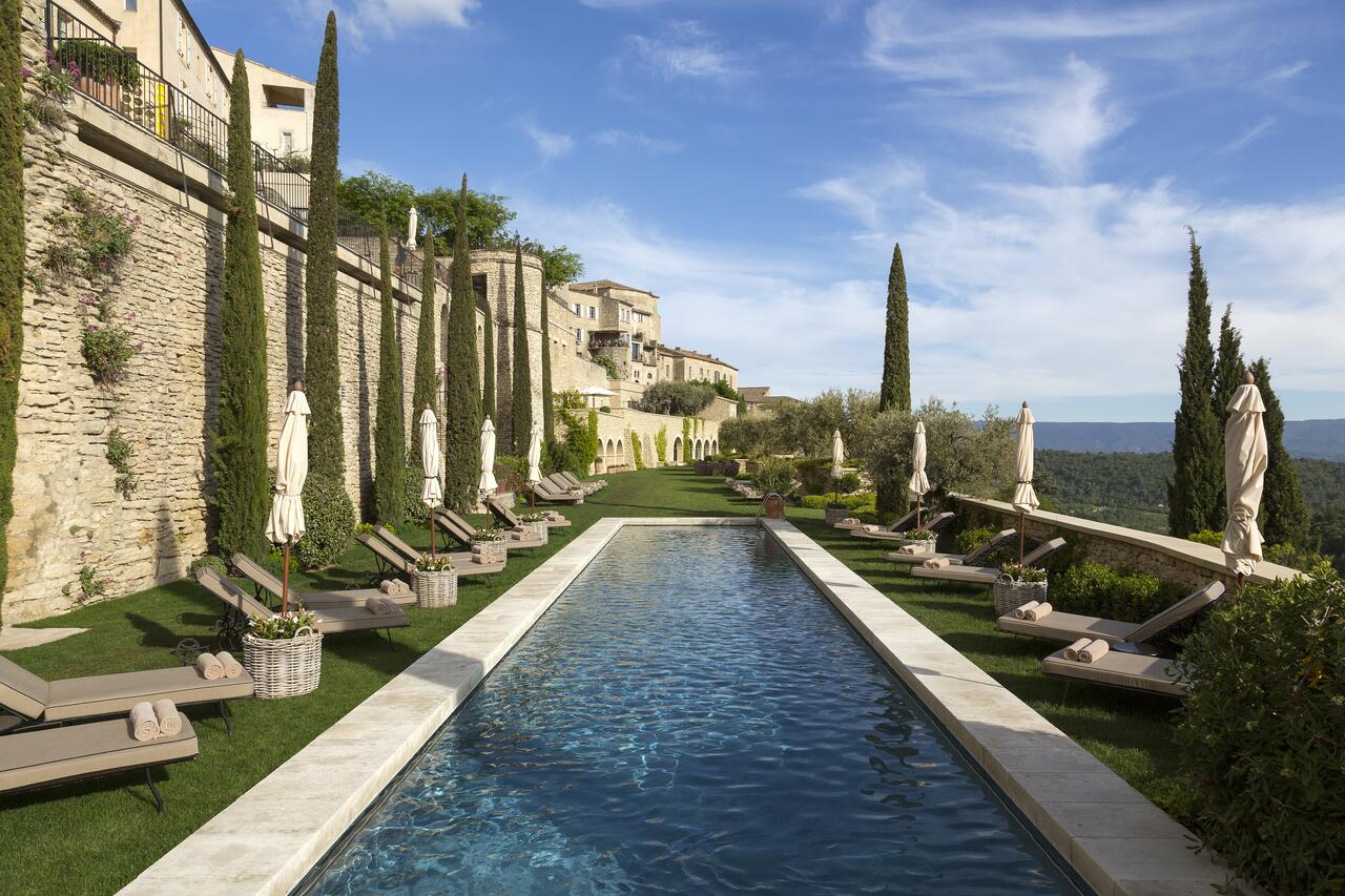 a long narrow pool flanked by cypress tress