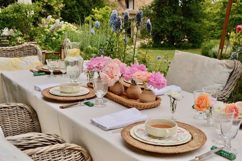 tablescape outside with pink and orange flowers and soup