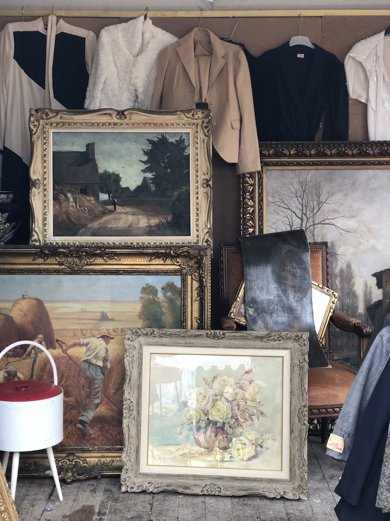 paintings and clothings at a french flea market