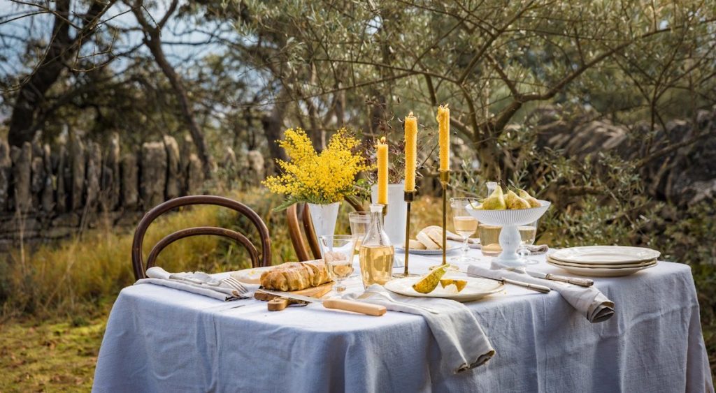 a table dressed with mimosa and candles