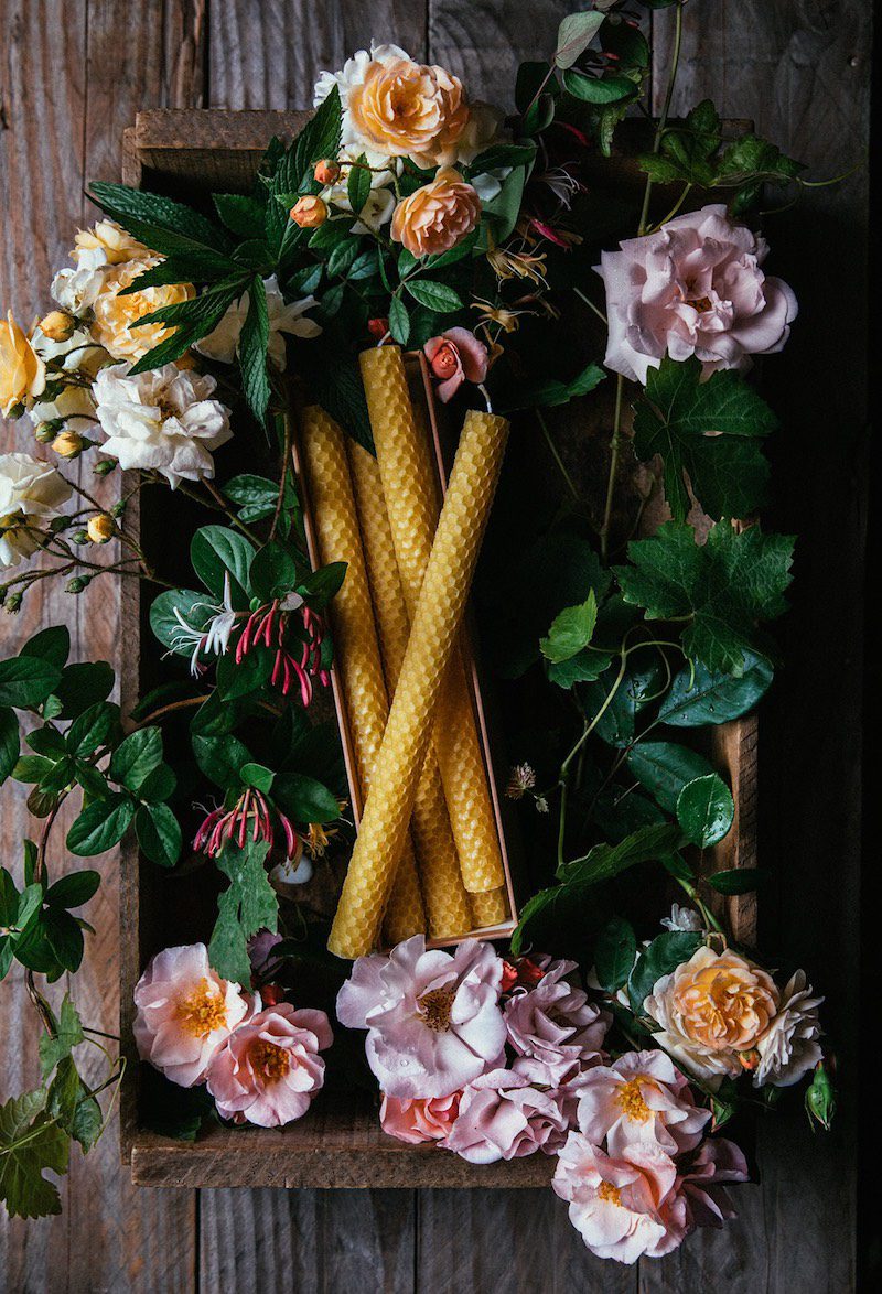 a box of candles shrouded in flowers