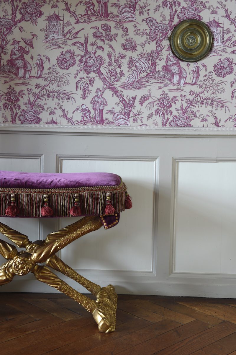 a purple hued toile de jouy with a footstool