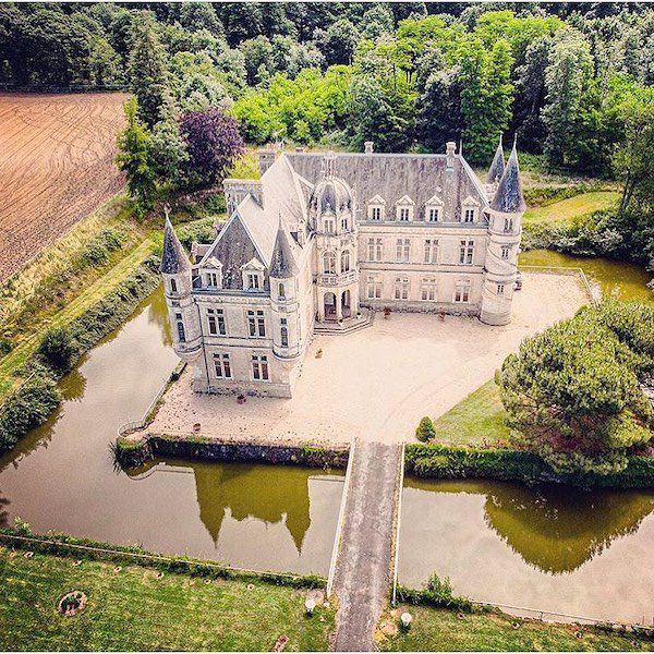 aerial view of large french chateau and moat