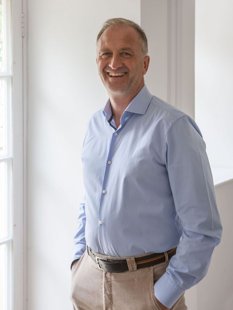 a smiling man in a light blue shirt