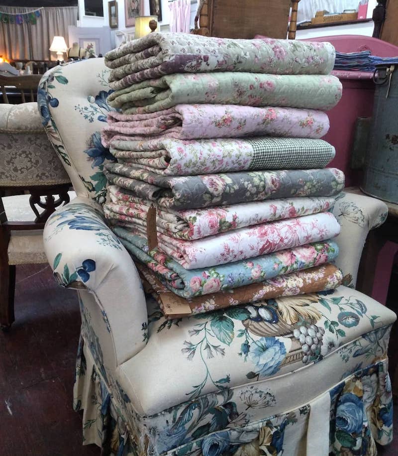 a stack of quilts on a chair