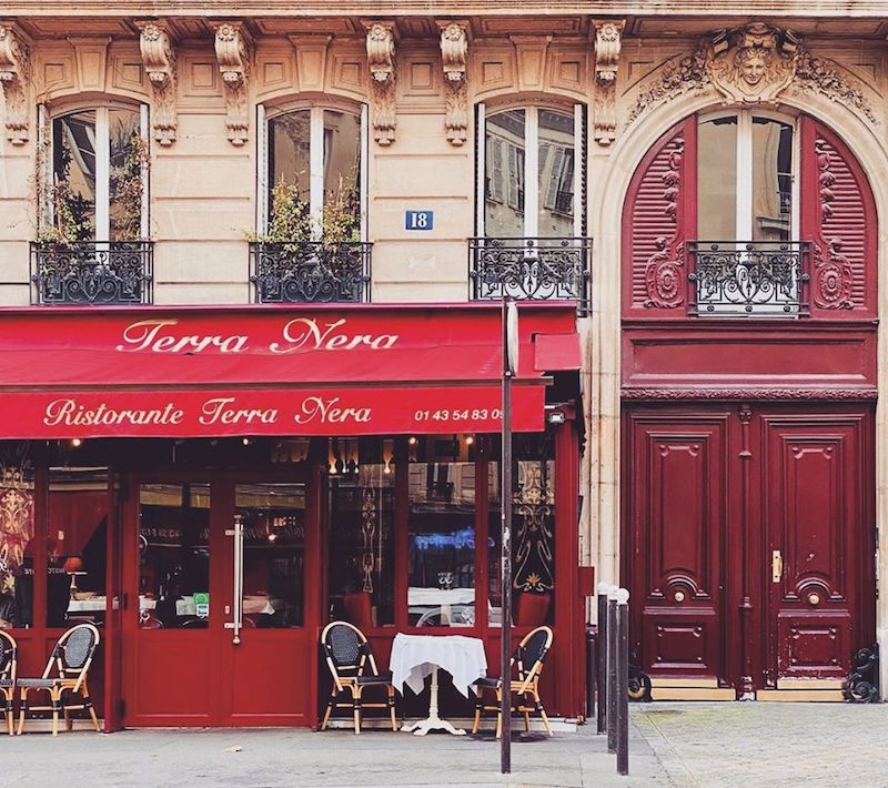 french bistro with red awning and red door