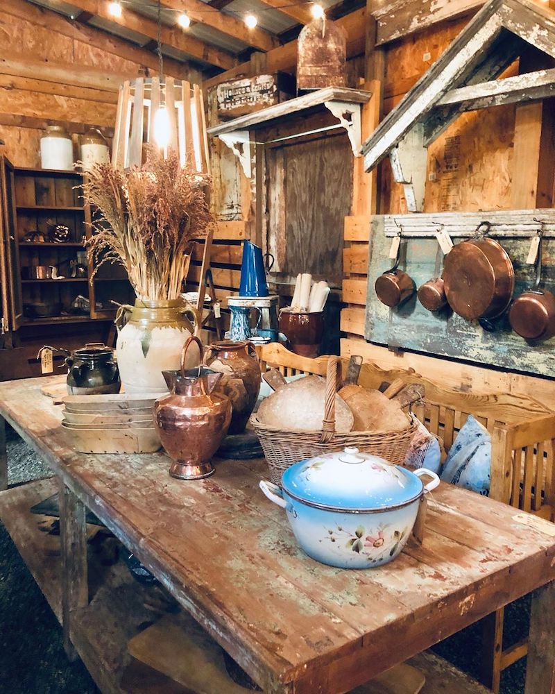 a farmhouse table with kitchen utensils on top of it
