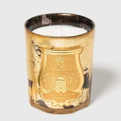 a candle in a gold leaf votive