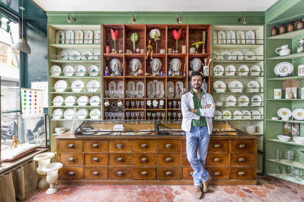 a man leaning against a large workers unit in a shop