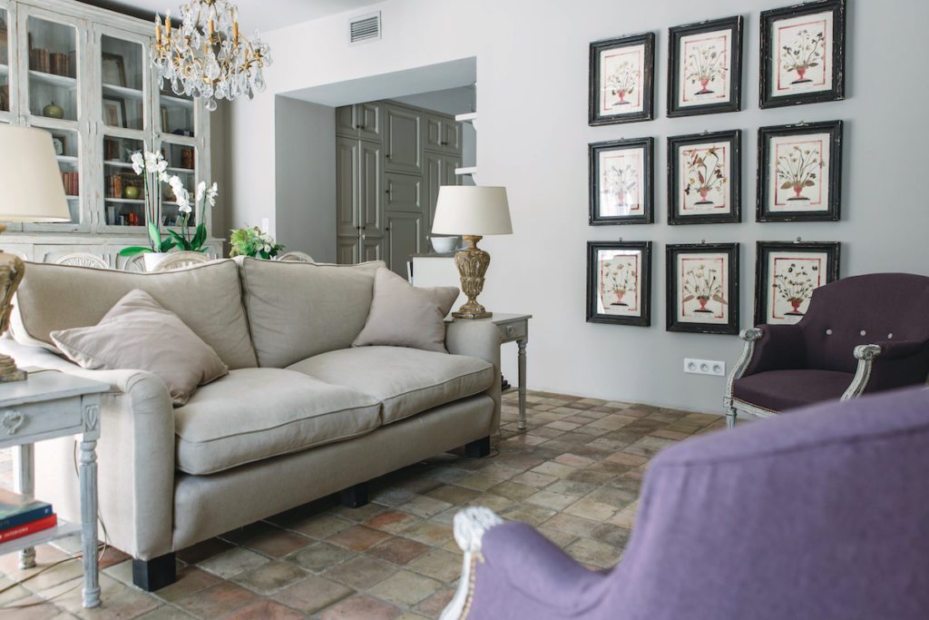 french living room with couch and paintings