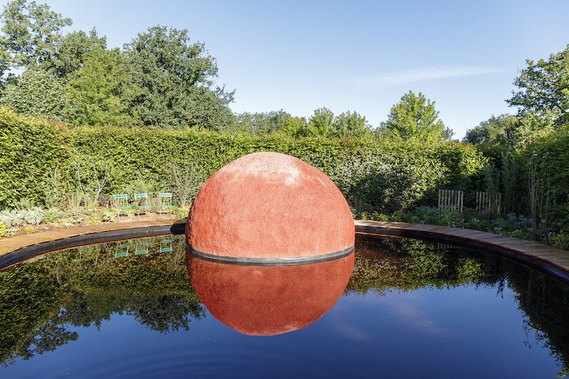 red sculpture in lake