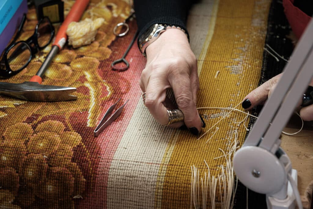 notre dame carpet close up hands