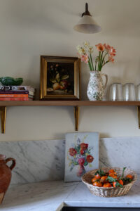 Organized kitchen with fresh cut flowers and art.