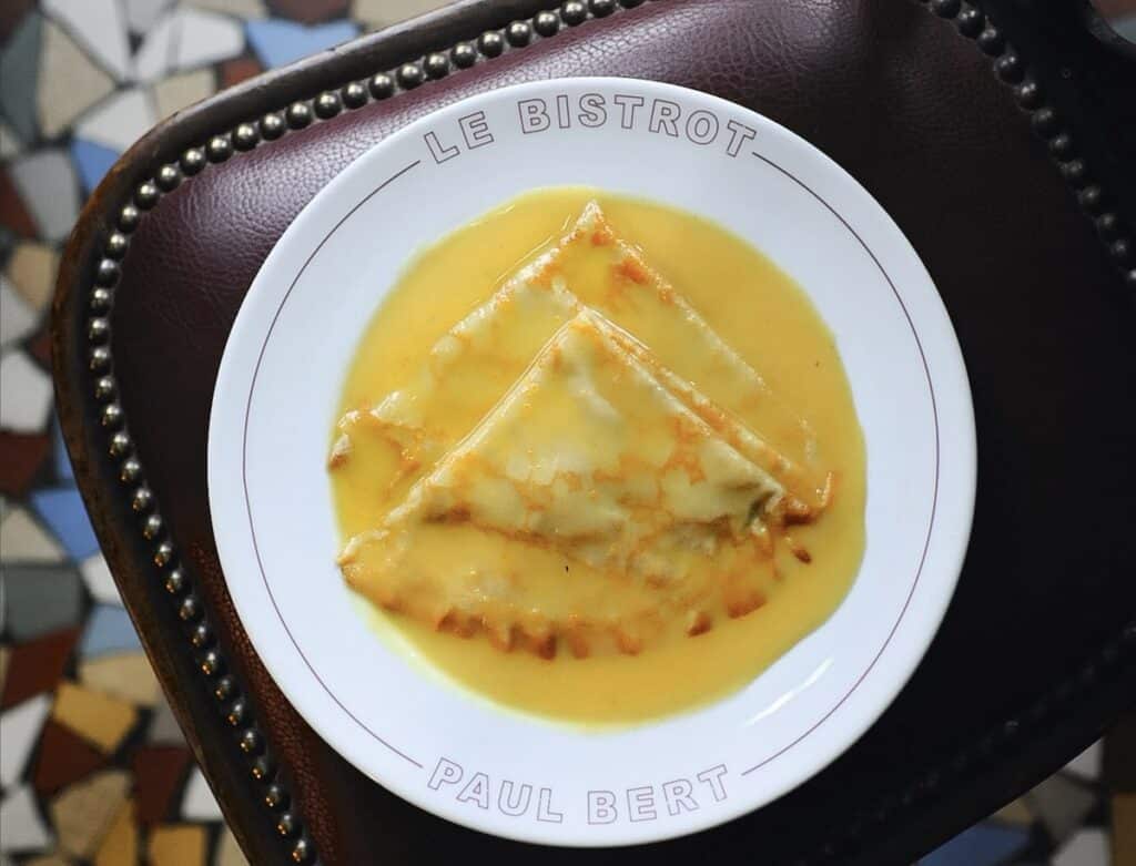 Crepes Suzette on a bistrost plate at Paul Bert in Paris, Fance.
