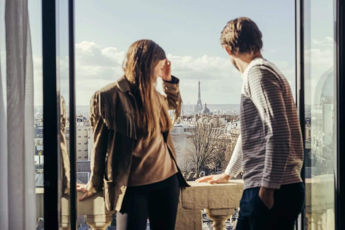 Oliver and Lina Nordin Gee overlooking the Parisian cityscape and Eiffel Tower.