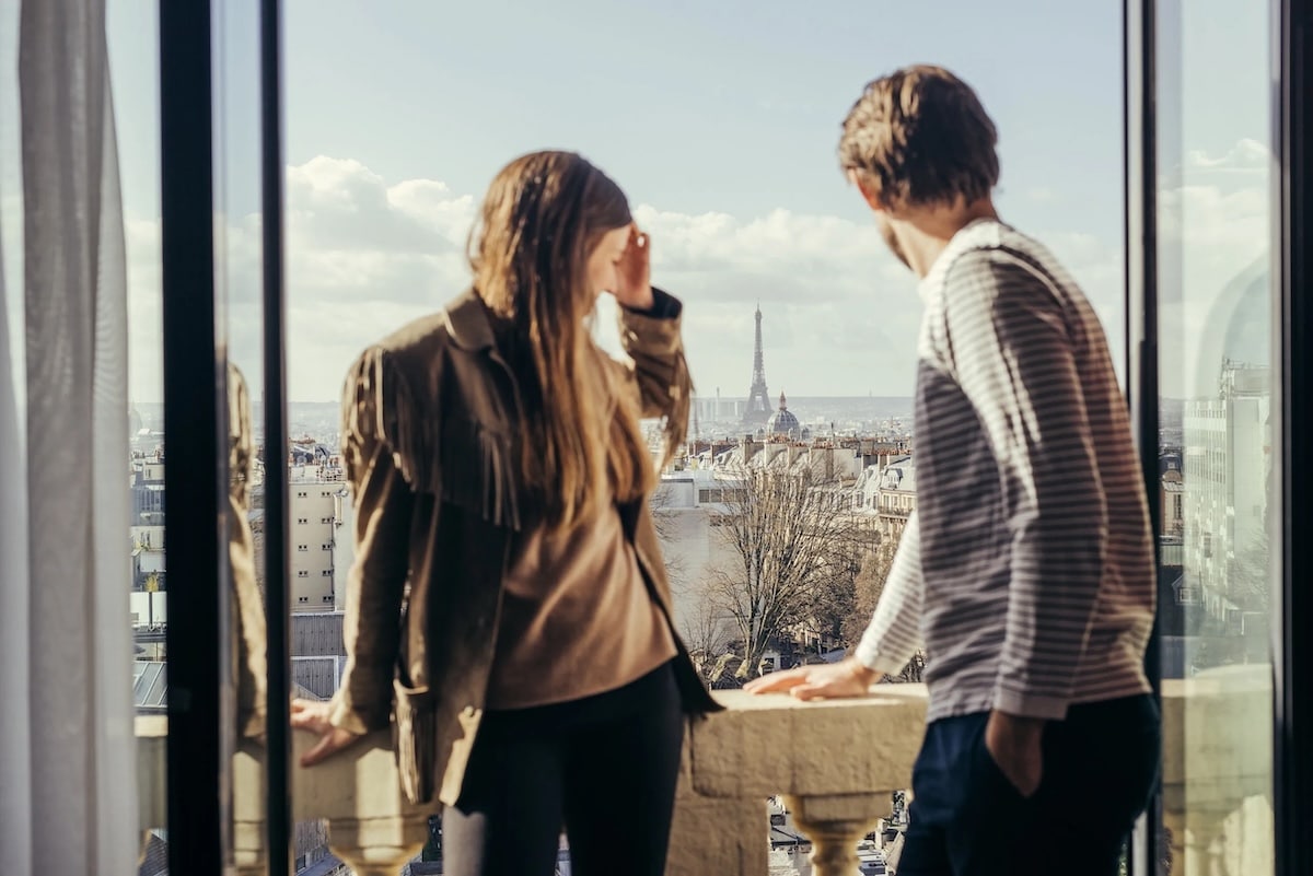 Oliver and Lina Nordin Gee overlooking the Parisian cityscape and Eiffel Tower.