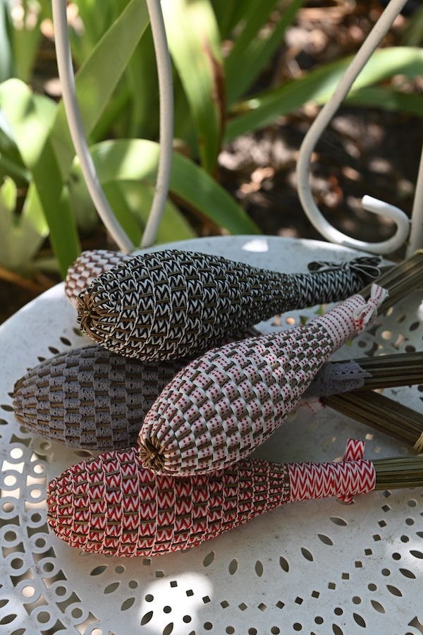 lavender wands stacked on a chair outside
