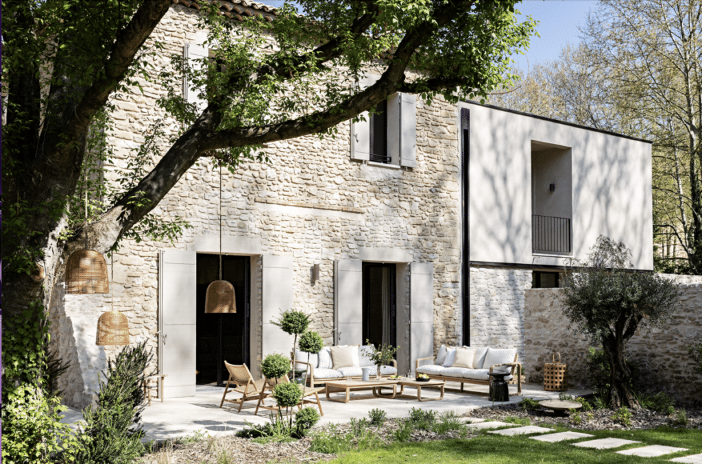 French stone home and garden terrace renovated with a modern architectural exterior.