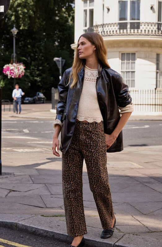Balzac cream knit sweater styled with leopard print pants and a leather jacket.
