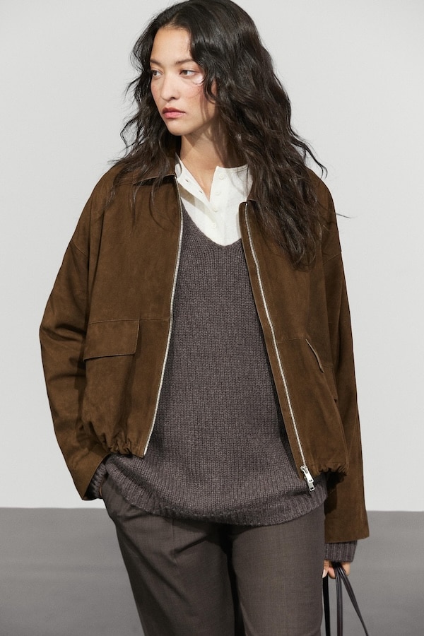 Massimo Dutti suede brown jacket styled with a brown knit sweater and a white button down shirt.