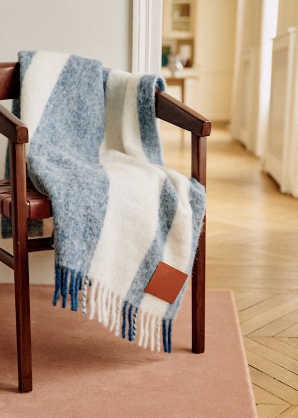 Woolen blue and white striped Sézane throw pillow with a leather patch.